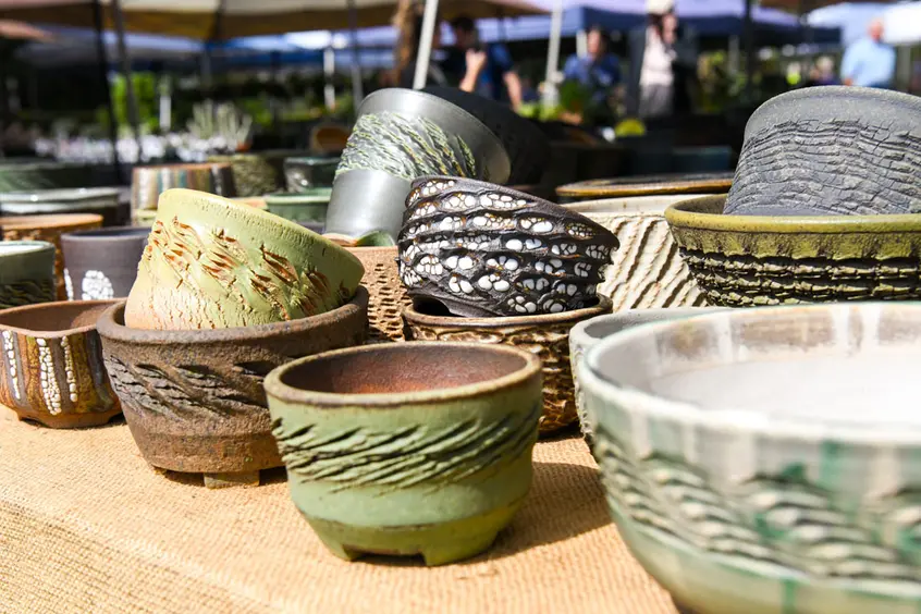 A table of ceramic pots on display.