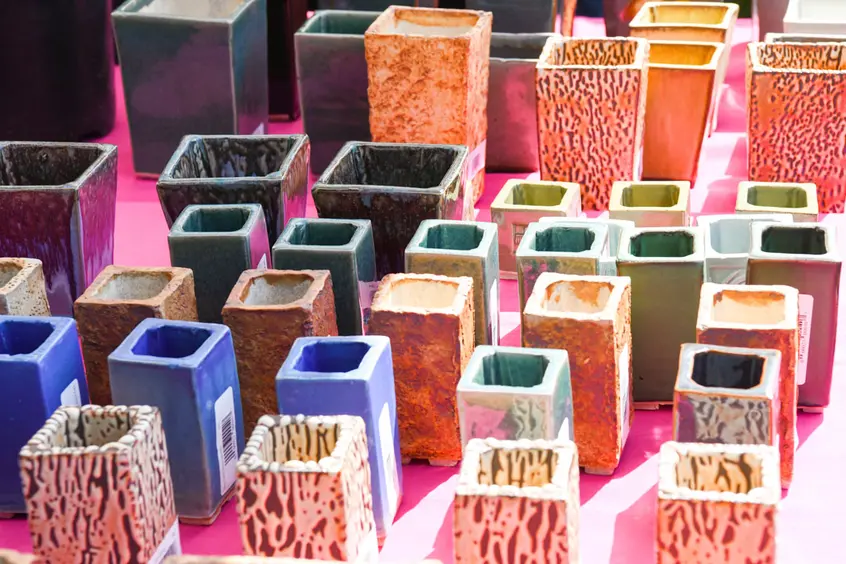 A table of square ceramic pots.